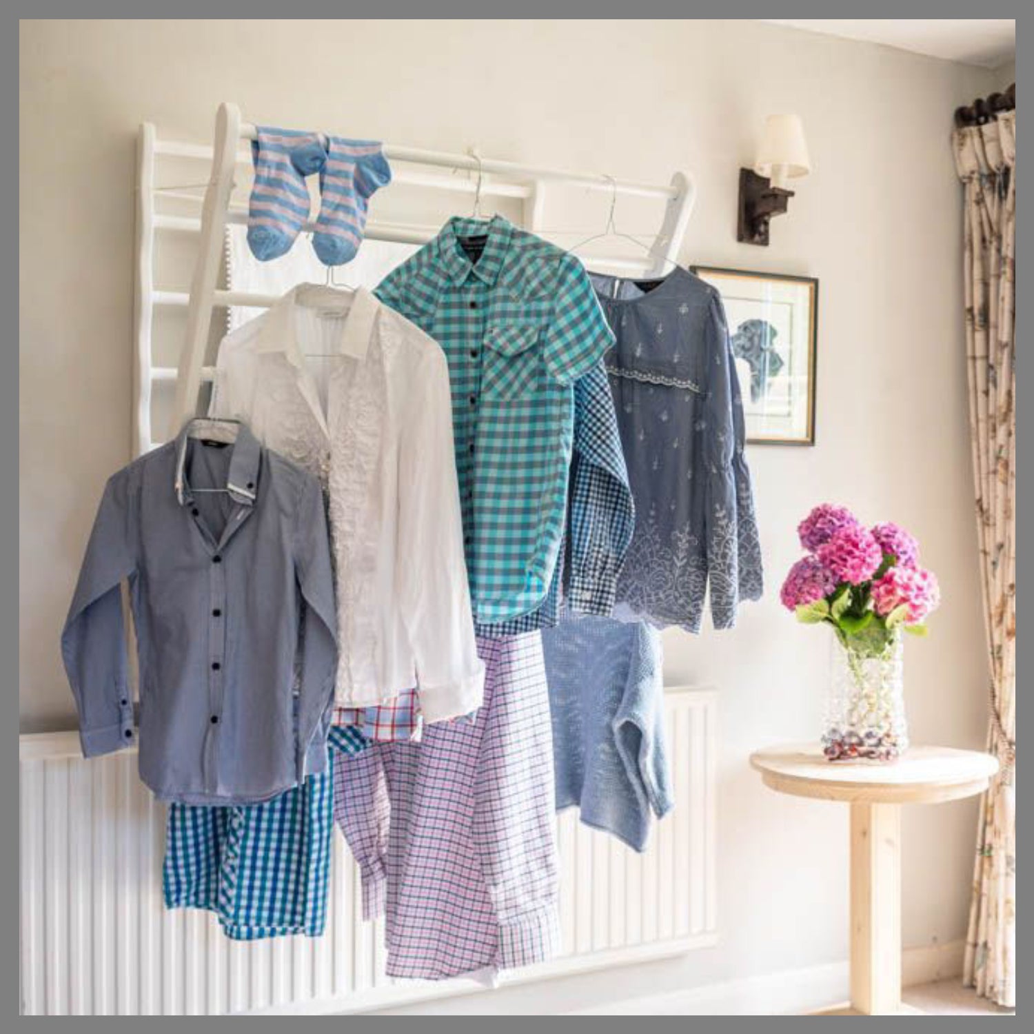 Laundry Ladder displaying clothes hanging on coat hangers 