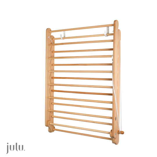 Quality Wooden Beech Clothes Airer, drying rack.  Folded neatly on a wall.