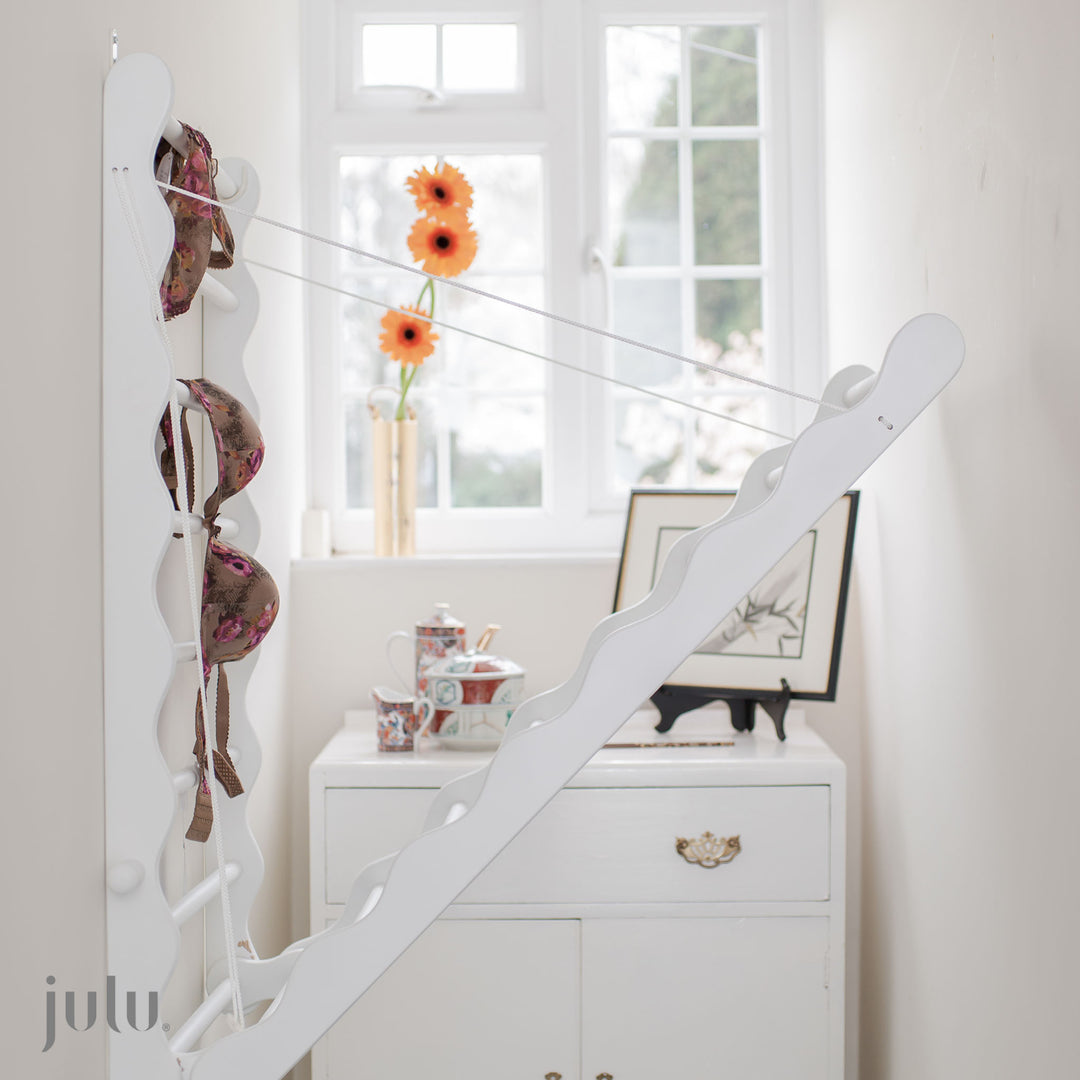 Photo shows wall mounted clothes airer in narrow hall way by Julu